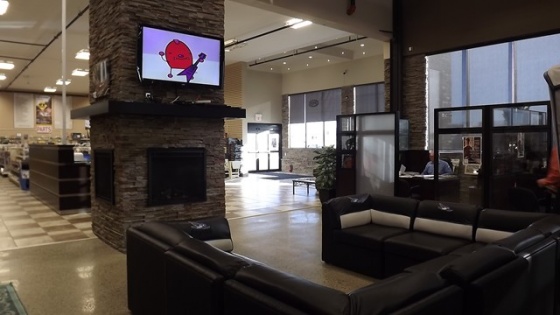 Happy Trails RV Inc. - Customer lounge with fireplaces, comfortable seating, and big screen TV